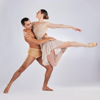 If you do nothing else today, just dance. Studio shot of a young man and woman performing a ballet recital against a grey background