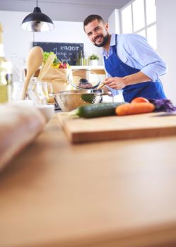Man preparing delicious and healthy food in the home kitchen.