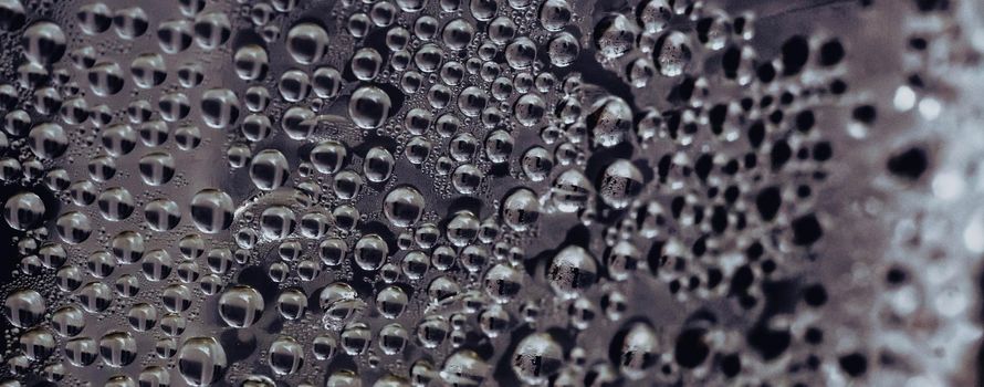 Many Water Rain Drops wet window condensation on glass. Fresh background. Textures formed by bubbles. Collection clear surface. Abstract real photo beautiful romantic cute wallpaper. Dark grey colour.