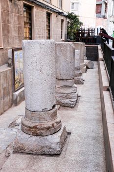 Cartagena, Murcia, Spain- July 25, 2019: Remains of pillars of roman road and temple on the street in Cartagena