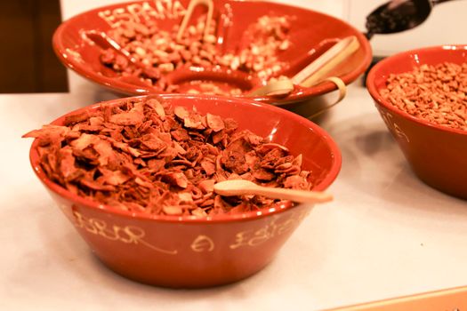 Murcia, Spain- July 17, 2022: Dehydrated and caramelized coconut flakes in a bowl in Spain