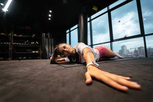 Young woman doing exercises in the gym during morning