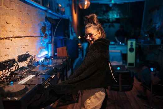 Beautiful female DJ dancing to techno