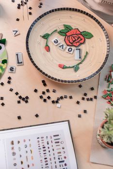 Workplace of mosaic maker: material and tools on wooden table. Top view. Still life. Copy space. Flat lay