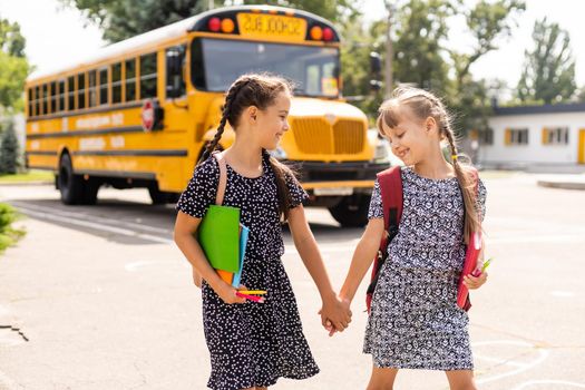 Education: Smiling Student Friends Ready For School next to school bus.