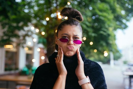Glamorous white girl fooling around in outdoor cafe. Gorgeous brunette female model in summer day.