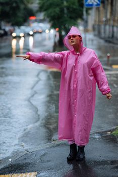 Woman catching taxi. Young girl trying to stop a cab. Woman calling a taxi on a rainy day.