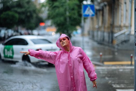 Woman catching taxi. Young girl trying to stop a cab. Woman calling a taxi on a rainy day.