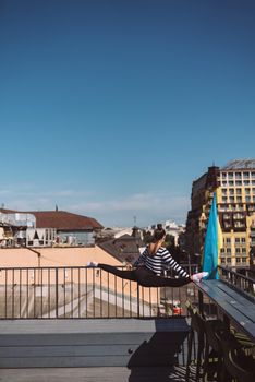 Woman is doing twine on the roof of the house
