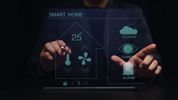 User controlling all the functions on a virtual screen of futuristic interface of smart home automation assistant.