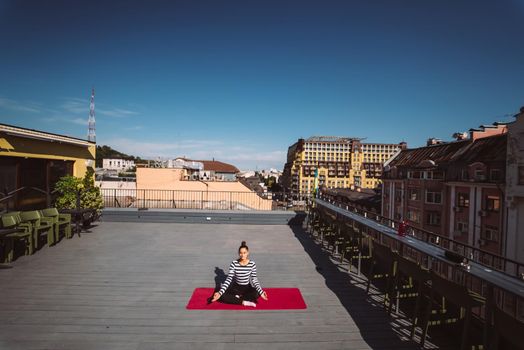 Beautiful young woman doing yoga exercise, meditation in lotus pose