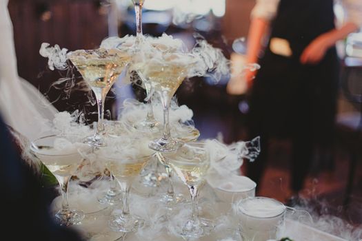 The bride and groom fill the champagne fountain. Wedding article. A happy couple. Love. Photos for printed products. Romance. Wedding catalog