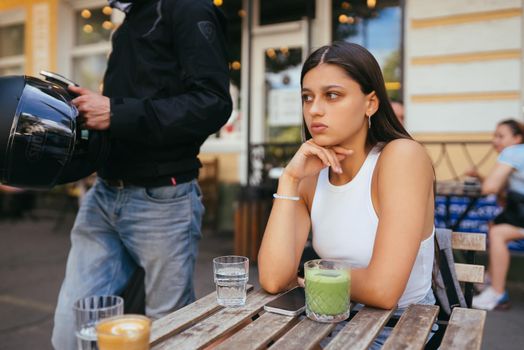 Tired sad woman in a trendy is resting in a cozy cafe, calm emotions. Traveling woman, lifestyle of loneliness