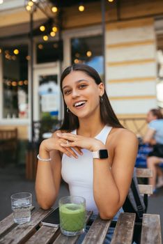 Young woman sitting in a street cafe