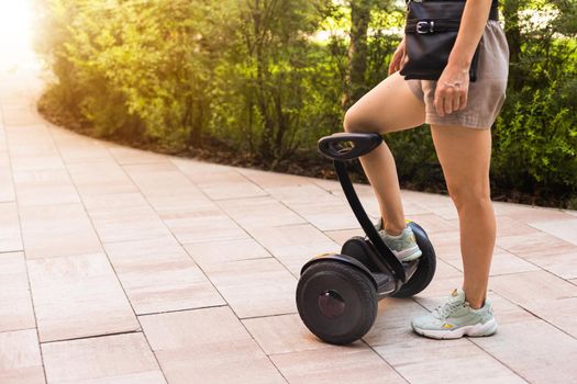 Beautiful woman stand near segway or hoverboard. self balancing electrical scooter