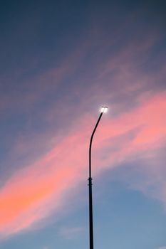 Lamppost at sunset . Sunset time. Copy space. An article about electricity. An article about pillars.