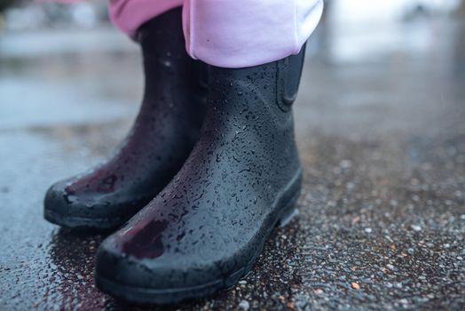 Young smiling woman with a pink raincoat on the street