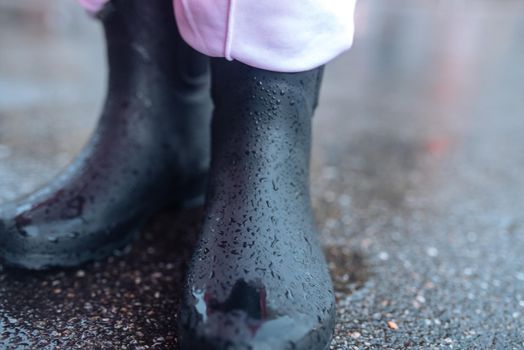 Young smiling woman with a pink raincoat on the street