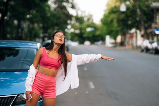 Beautiful Young Woman tourist Pleasant walk in the City Center catching taxi