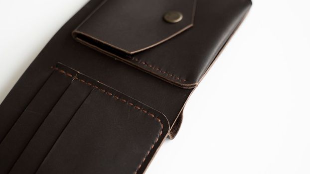 Man's open handmade dark brown genuine leather wallets on a white background. Leather goods and accessory