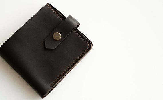 Man's handmade dark brown genuine leather wallets on a white background. Leather goods and accessory