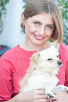 portrait beautiful young blonde smiling and pet dog Chihuahua. High quality photo