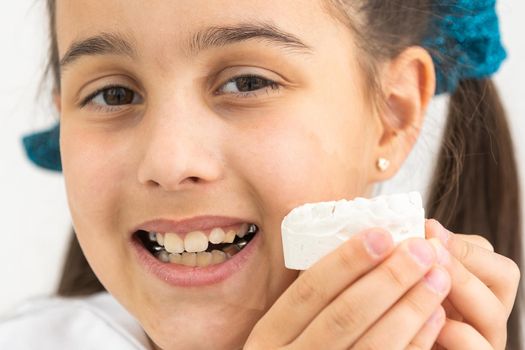 little girl with plaster cast of teeth and with the metal apparatus on the teeth