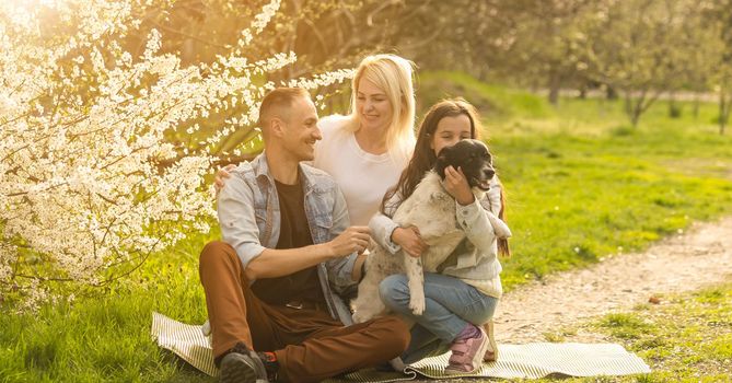Happy family with dog in the garden