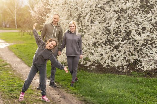 family in blossom garden with trees