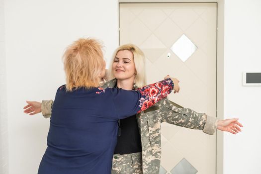 military woman and elderly mother at home.