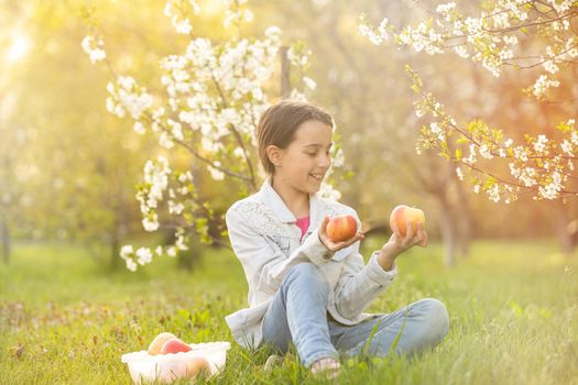 Beautiful preteen girl enjoy spring apple blooming. Little preschool girl in garden tree flowers. Springtime