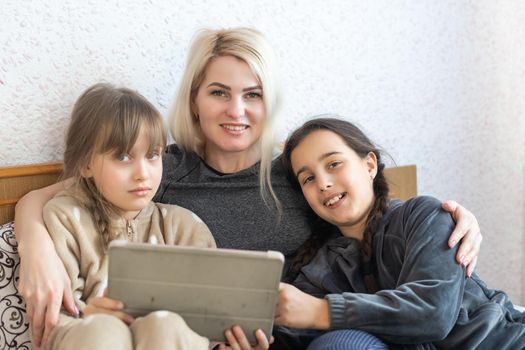 Mother and daughter looking at tablet.