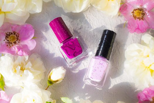 Nail polish bottle in fresh colors . An article about nail polishes. Cosmetology. Cosmetic products.