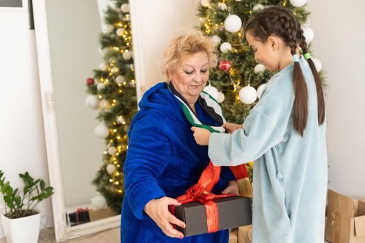 grandmother and granddaughter christmas with flag of united arab emirates at christmas.