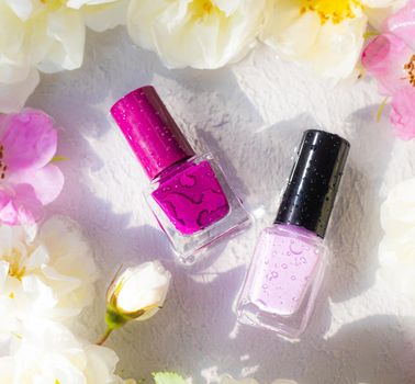 Nail polish bottle in fresh colors . An article about nail polishes. Cosmetology. Cosmetic products.