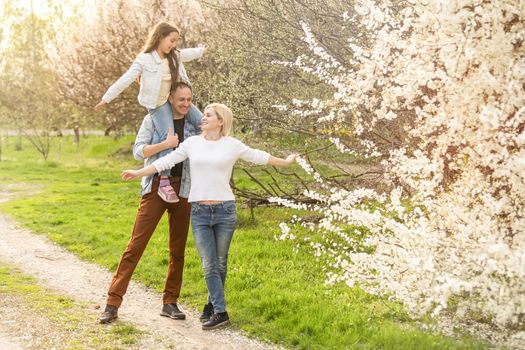 family in a blooming spring garden. Concept of happy family.