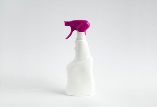 White blank plastic spray detergent bottle with a violet sprayer isolated on white background. Packaging template mockup