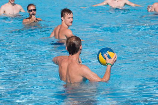young people playing volleyball with a ball on the water in the pool during the summer holidaysSharm el Sheikh, Egypt, June 6, 2012