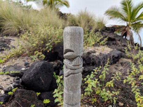 Wood Carving of Hawaiian God in Hawaiian temple (heiau) at Aiopio Beach on Big Island, Hawaii.