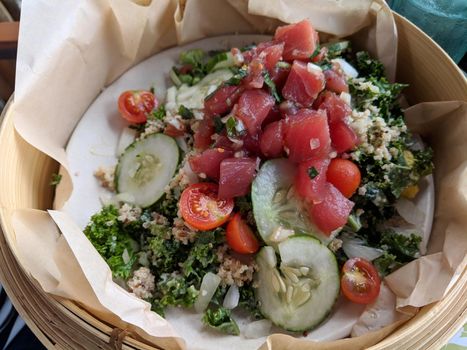 Ahi Quinoa Salad with tomatoes, cucumbers, and onions.