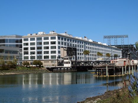 Historic 4th bridge on Mission Creek, birds flying in the air, and ballpark in distance in San Francisco.