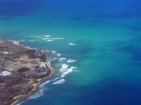 Aerial of Waves rolling towards Barbers Point on Oahu in the state of Hawaii. 