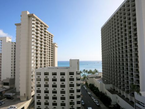 Waikiki - April 24, 2016: Waikiki Hotels, street and Ocean during day.                     