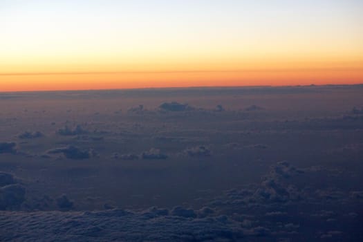 Aerial of Sunrise light over the world full of clouds over the pacific ocean.