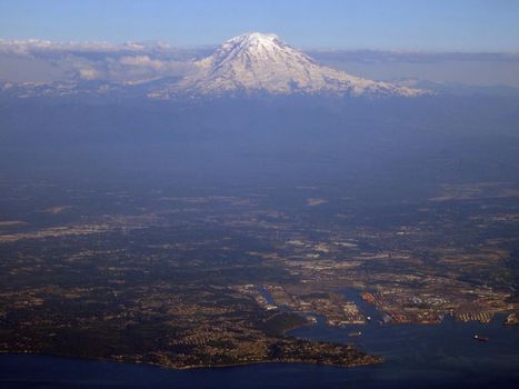 Aerial view Tacoma Harbor and City with coast and Mount Rainier visible in the distance on June 26, 2016 in Seattle, WA.