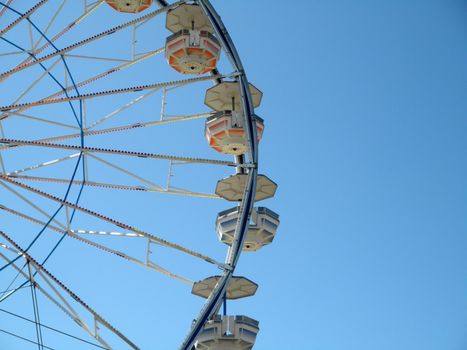 San Francisco - June 20, 2010: Close-up of Ferris Wheel Carts at Fair.  A Ferris wheel is an amusement ride consisting of a rotating upright wheel with multiple passenger-carrying components attached to the rim in such a way that as the wheel turns, they are kept upright, usually by gravity.