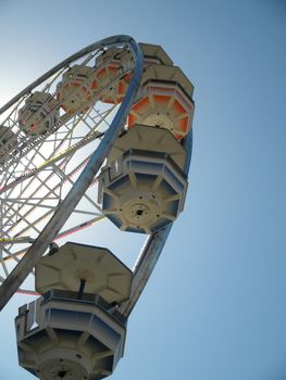 San Francisco - June 20, 2010: Close-up of Ferris Wheel Carts at Fair.  A Ferris wheel is an amusement ride consisting of a rotating upright wheel with multiple passenger-carrying components attached to the rim in such a way that as the wheel turns, they are kept upright, usually by gravity.