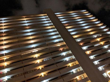 Honolulu - October 24, 2018: Looking up a Condo Building with outdoor hallway at Night.