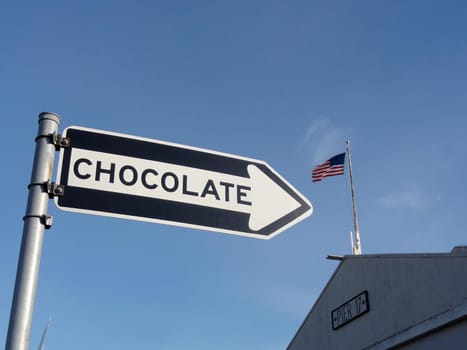 Chocolate Sign in front of Pier 17 and USA Flag in San Francisco, California.