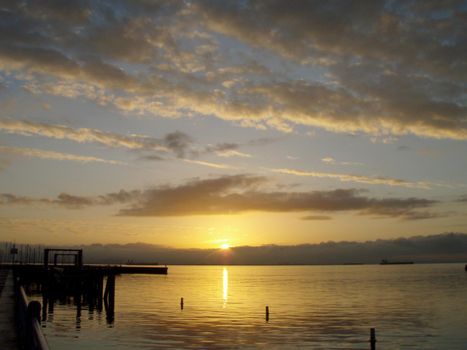 Sunrise over San Francisco Bay with light reflecting on the water.